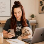 Business owner creating searchable Pinterest Pins on a laptop with keyword research notes and evergreen blog content in a bright home office.