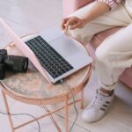 Small business owner building online authority by creating helpful content, recording a podcast interview, and reviewing SEO analytics on a laptop in a bright home office.