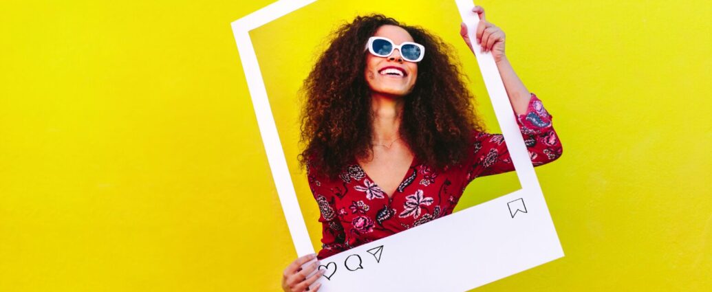 Small business owner planning a social media strategy while holding an Instagram sign creating helpful content designed to reach the right audience online.
