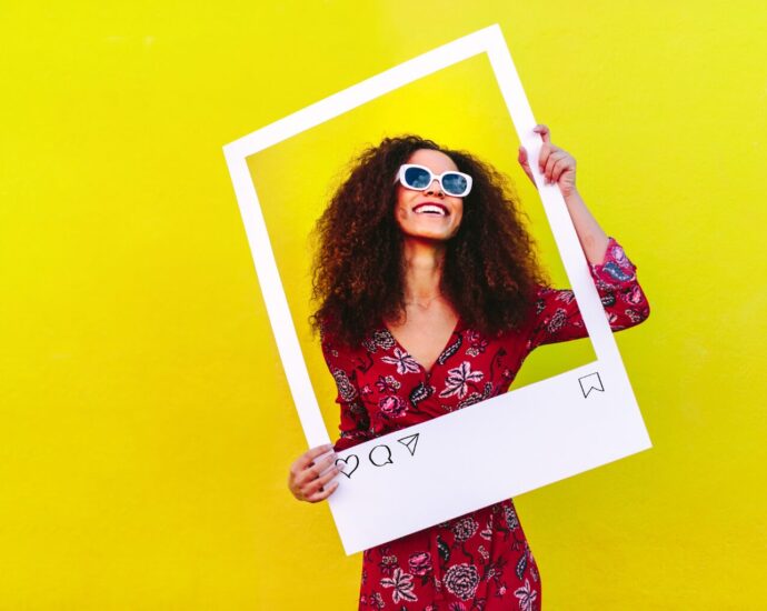 Small business owner planning a social media strategy while holding an Instagram sign creating helpful content designed to reach the right audience online.