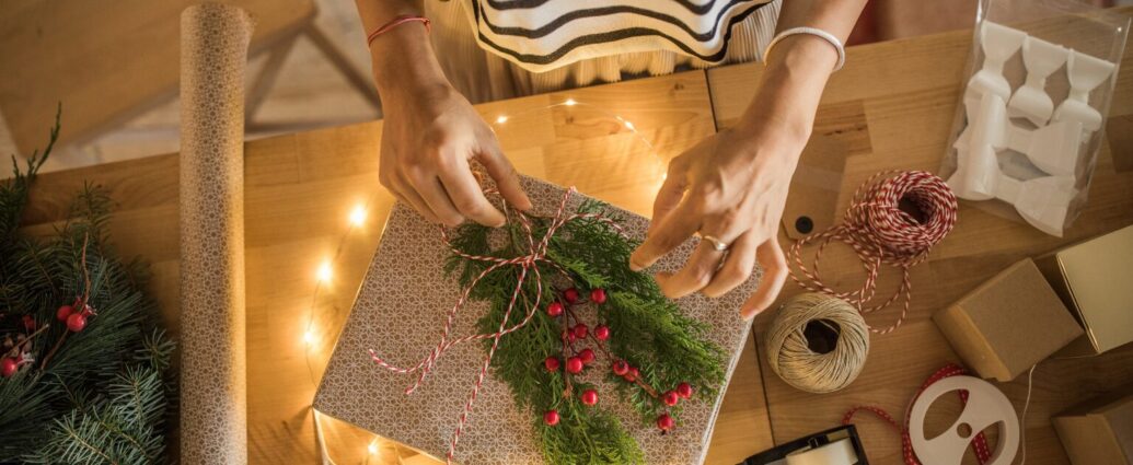 Small business owner planning holiday marketing content for Meta's four phases of holiday shopping.