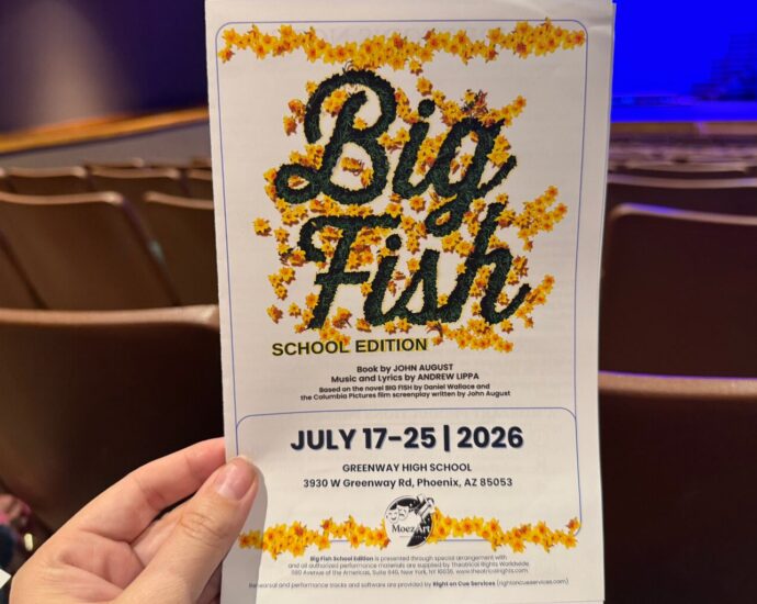 Attending Big Fish performing on stage during Moezart Theatre Productions' community theatre production.