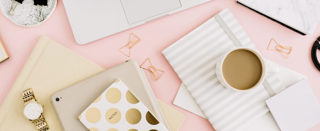 Business owner thoughtfully creating educational content at a laptop with a notebook and coffee, representing ethical marketing and trustworthy content creation.