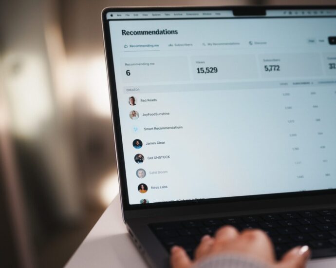 Laptop and coffee on a desk representing a personal review of Kit email marketing for content creators.